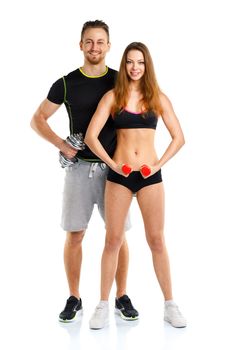 Sport couple - man and woman with dumbbells on the white background