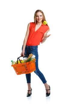 Happy young woman holding a basket full of healthy food on white background. Shopping