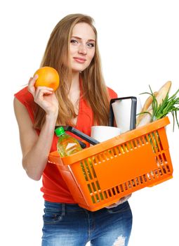 Happy young woman holding a basket full of healthy food on white background. Shopping