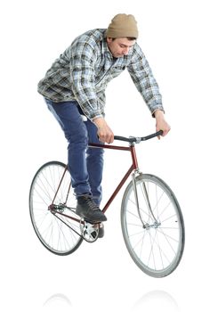 Young man doing tricks on a bicycle on a white background