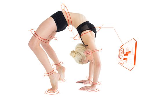 Side view of a fit young woman doing the wheel pose against fitness interface