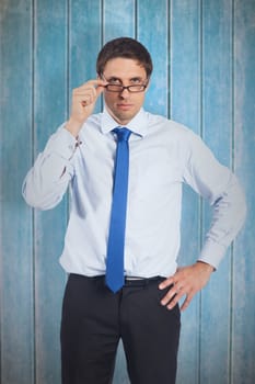 Thinking businessman tilting glasses against wooden planks