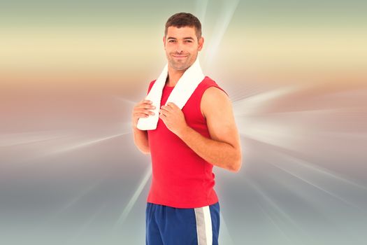 Fit man smiling at camera against abstract background