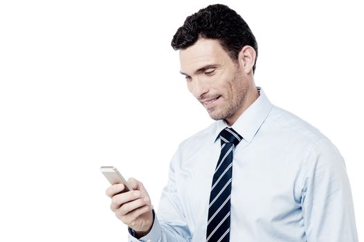 Businessman reading messages on cell phone