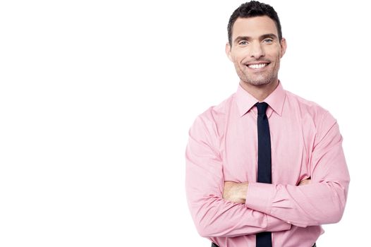 Confident male executive posing with folded arms