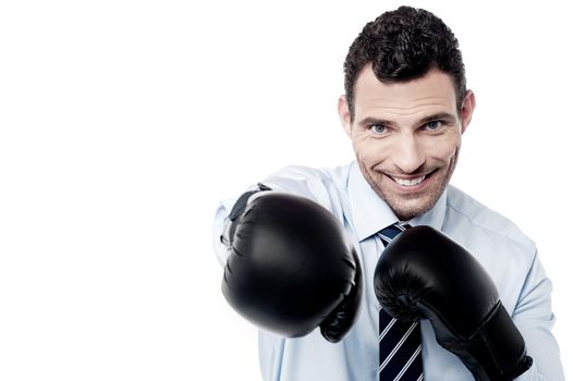 Happy businessman ready to fight with boxing gloves