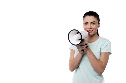 Smiling woman proclaiming into megaphone casually