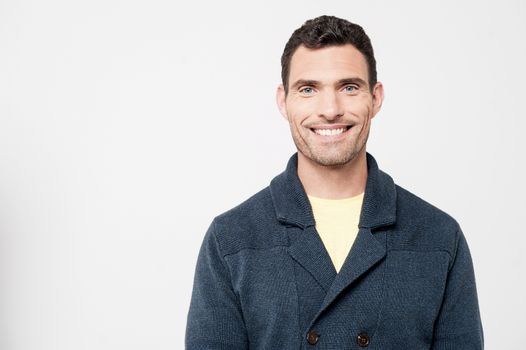 Happy casual man posing over grey background