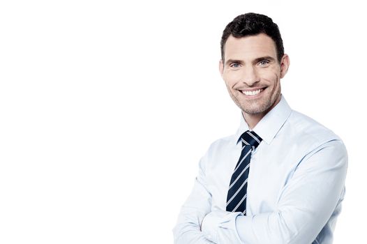 Happy businessman posing with crossed arms