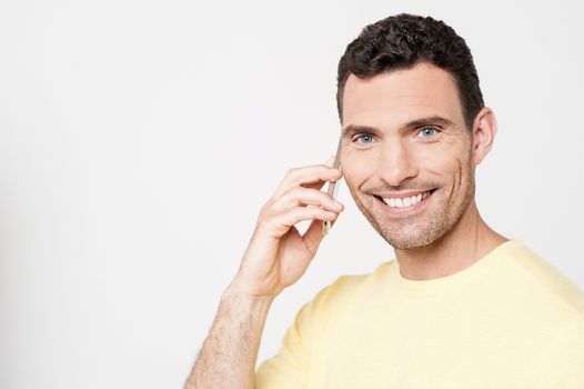 Casual man talking on his mobile phone