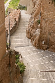 old stone stairs down in a medieval village views from the top