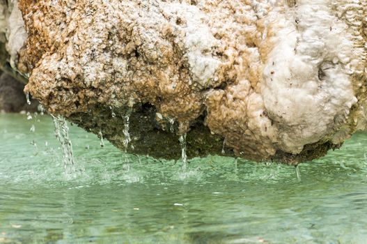 This is a detail of a fountain with rock.