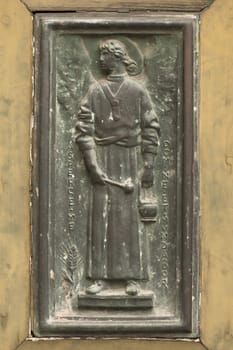 Detail of an ancient bronze sculpture placed on a door