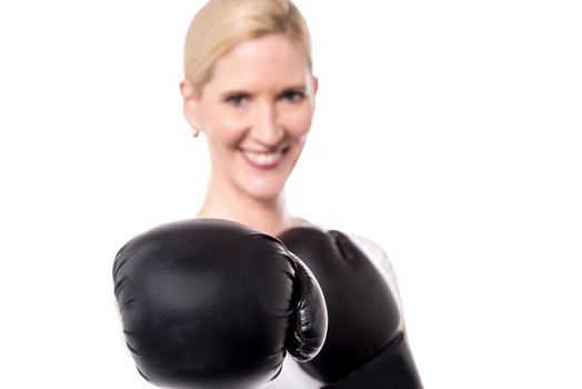 Closeup of woman posing with black boxing gloves