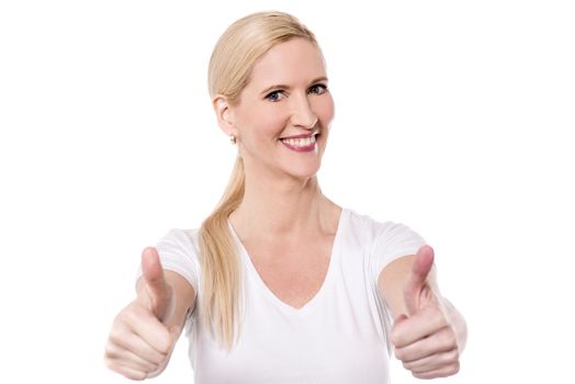 Happy woman making thumb up gesture