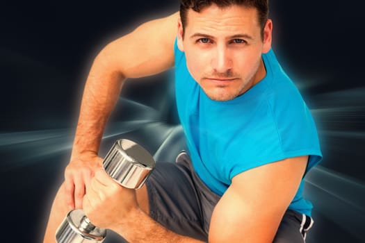 Portrait of a fit young man exercising with dumbbell against abstract background