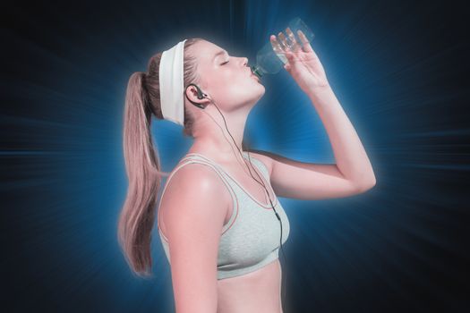 Sporty blonde drinking water against abstract background