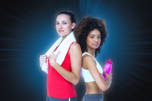 Fit women standing with waterbottle and towel against abstract background
