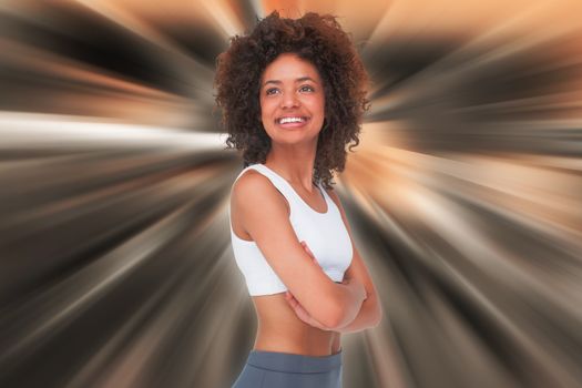 Smiling fit young woman with arms crossed against abstract background