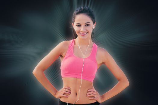 Full length of a sporty young woman pointing away against abstract background