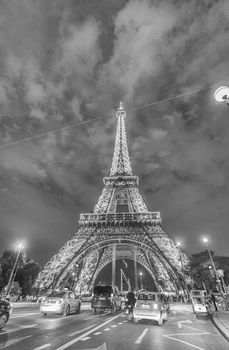 PARIS - JUNE 18, 2014: Eiffel Tower lights and traffic. The tower is the most visited monument in France.