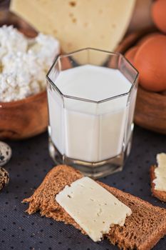 still life with dairy products as milk, cheese cottage cheese eggs and bread 