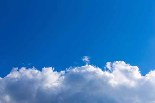 White fluffy clouds on blue sky background