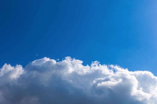 White fluffy clouds on blue sky background