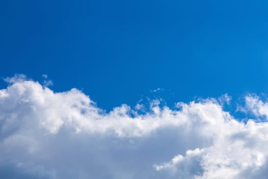 White fluffy clouds on blue sky background