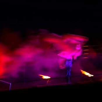 Smoke performer in motion at night