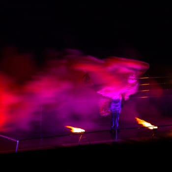 Smoke performer in motion at night