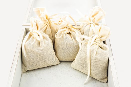 Textile sachet pouches inside white box