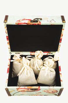 Gift box with textile pouches on white background