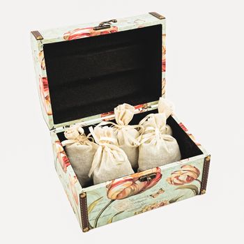 Gift box with textile pouches on white background