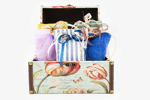 Decorative textile sachet pouches in gift box on white background
