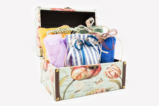 Decorative textile sachet pouches in gift box on white background