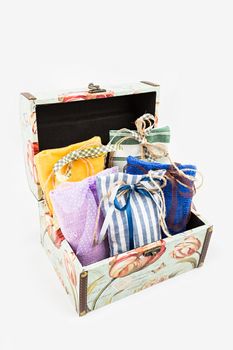 Decorative textile sachet pouches in gift box on white background