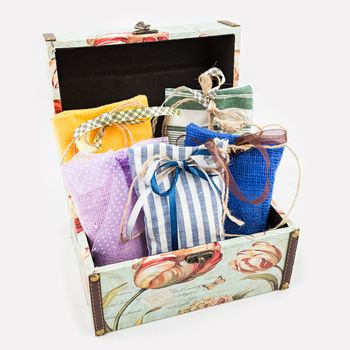 Decorative textile sachet pouches in gift box on white background