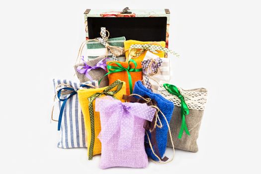 Decorative textile sachet pouches with gift box on white background