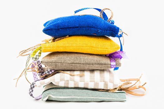 Decorative textile sachet pouches on white background