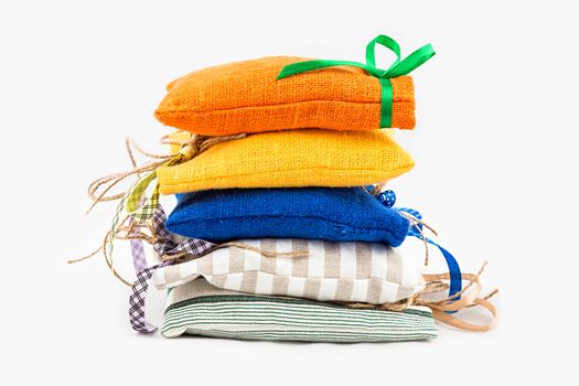 Decorative textile sachet pouches on white background