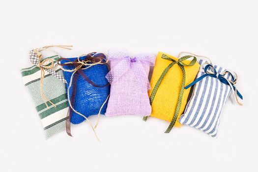 Decorative textile sachet pouches on white background