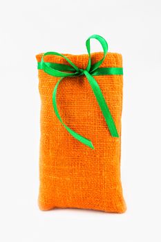 Decorative textile sachet pouch with a ribbon and bow on white background
