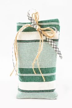 Decorative textile sachet pouch with a ribbon and bow on white background