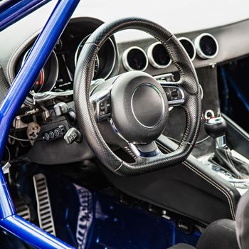 Steering wheel in interior of the sports car