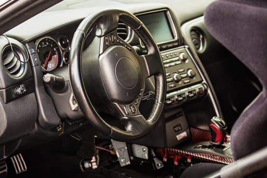 Steering wheel and dashboard in interior of the sports car