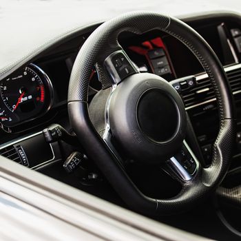 Steering wheel in interior of the sports car