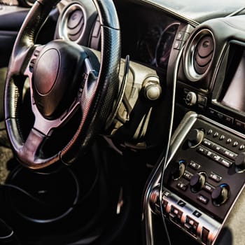 Steering wheel and dashboard in interior of the sports car