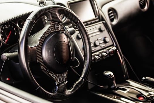 Steering wheel in interior of the sports car