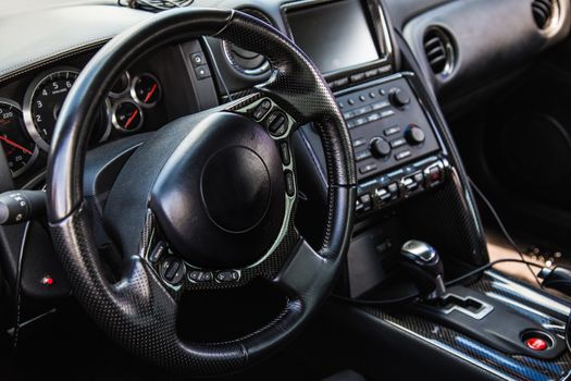 Steering wheel and dashboard in interior of the sports car